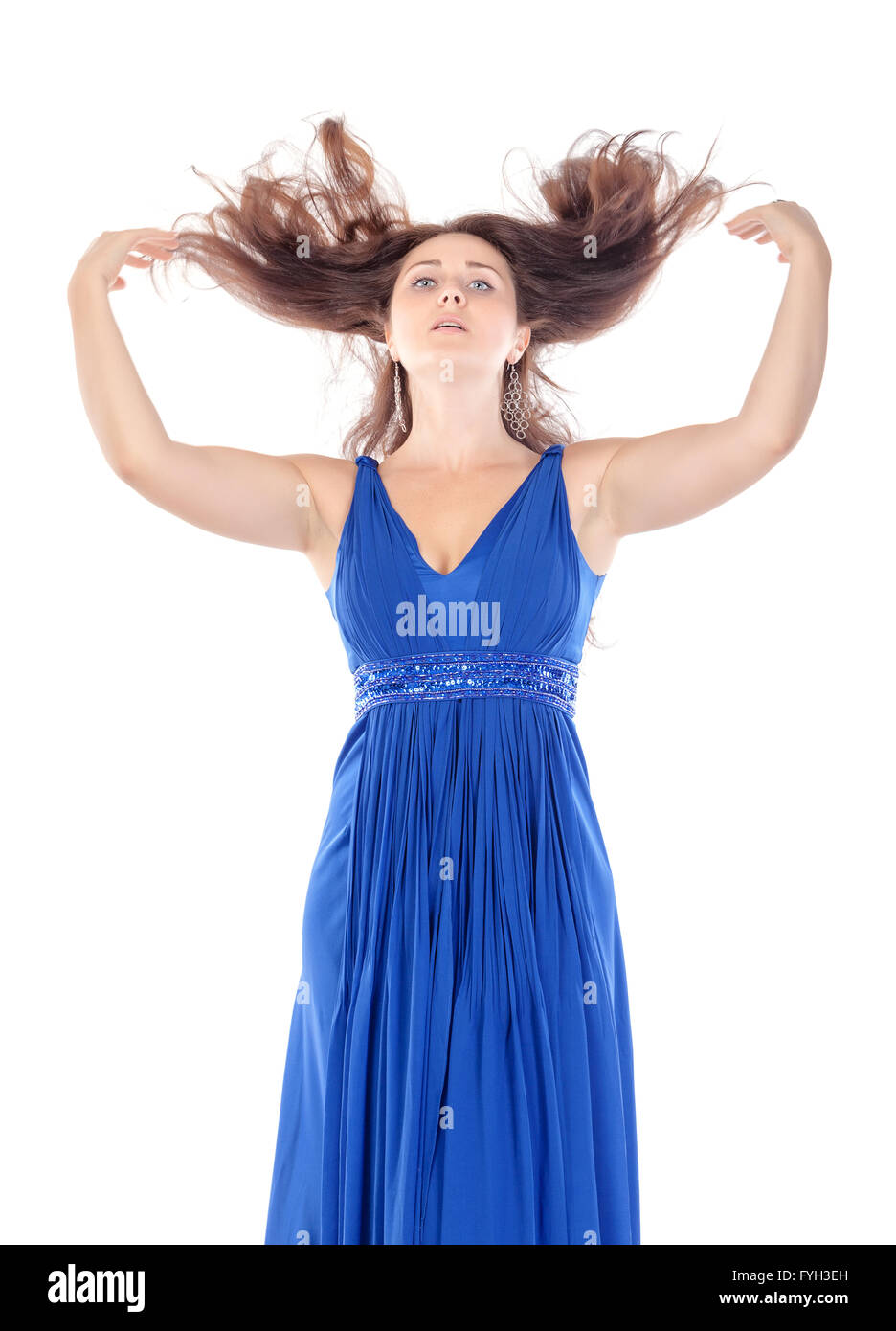 Portrait of a beautiful young woman in blue dress with streaming hair ...