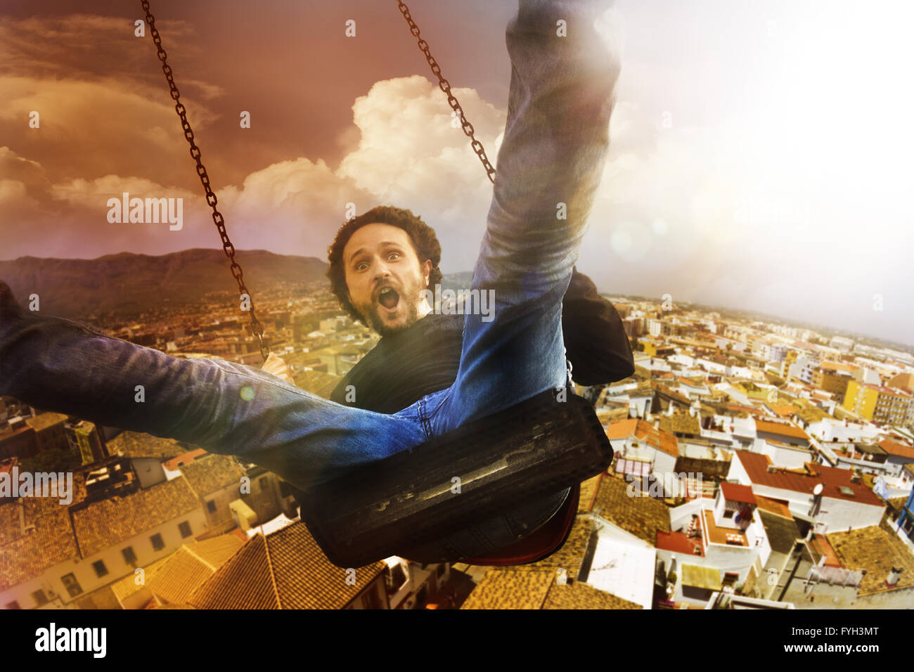 concept crazy, mad and happy man climbed a swing Stock Photo