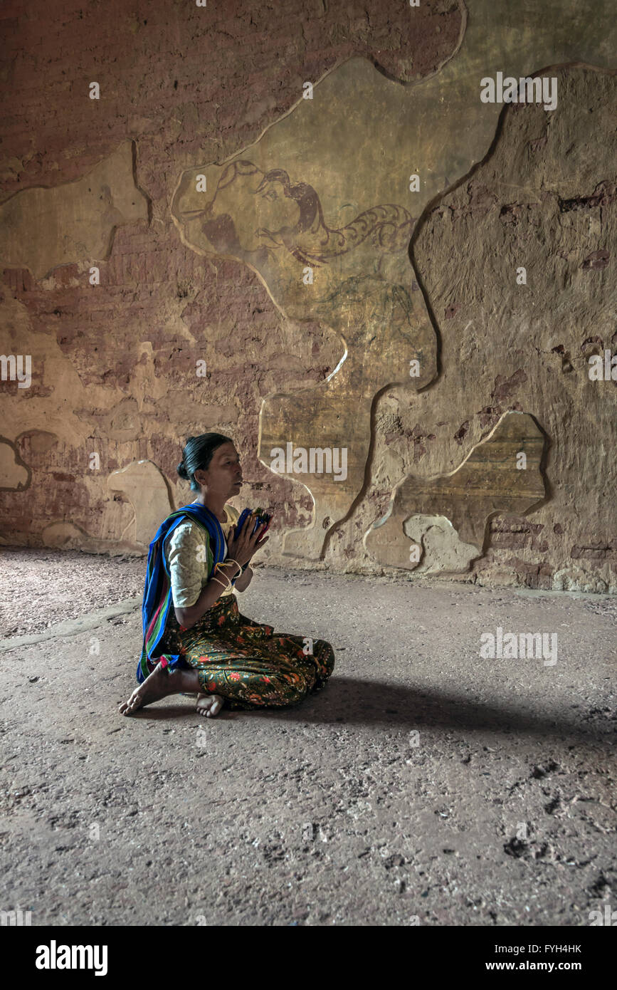 Praying woman, Sulamini temple, Old Bagan, Myanmar Stock Photo