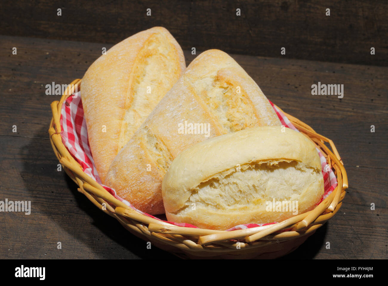 Various types of bread rolls, cakes, bun, in a basket, on a rustic