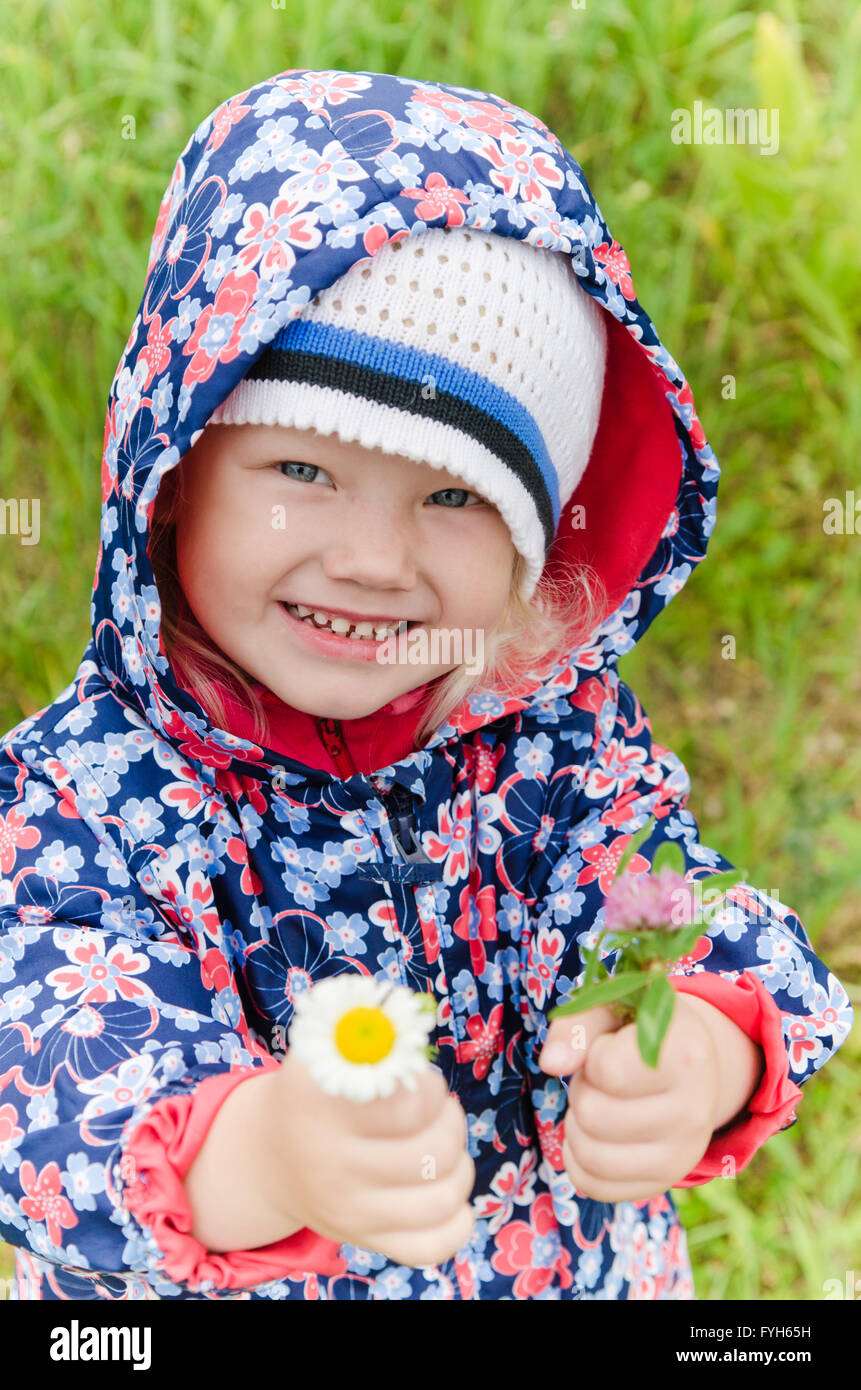 Portrait of a little girl with wild flowers in the hands Stock Photo ...