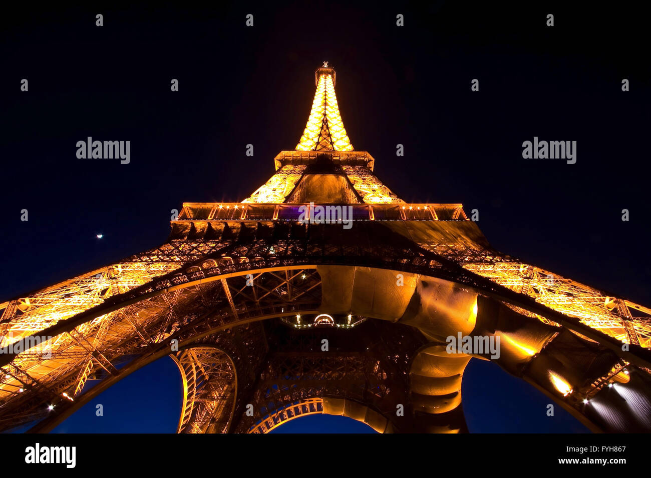 PARIS - APR 20: Eiffel Tower Light Performance Show in Dusk with the Moonon April 20 Stock Photo