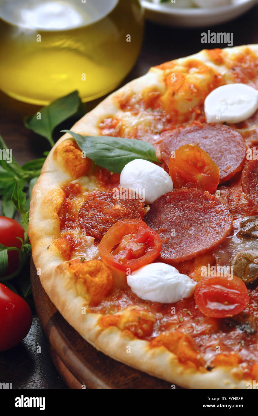 Salami and fresh tomato pizza on wooden table Stock Photo Alamy