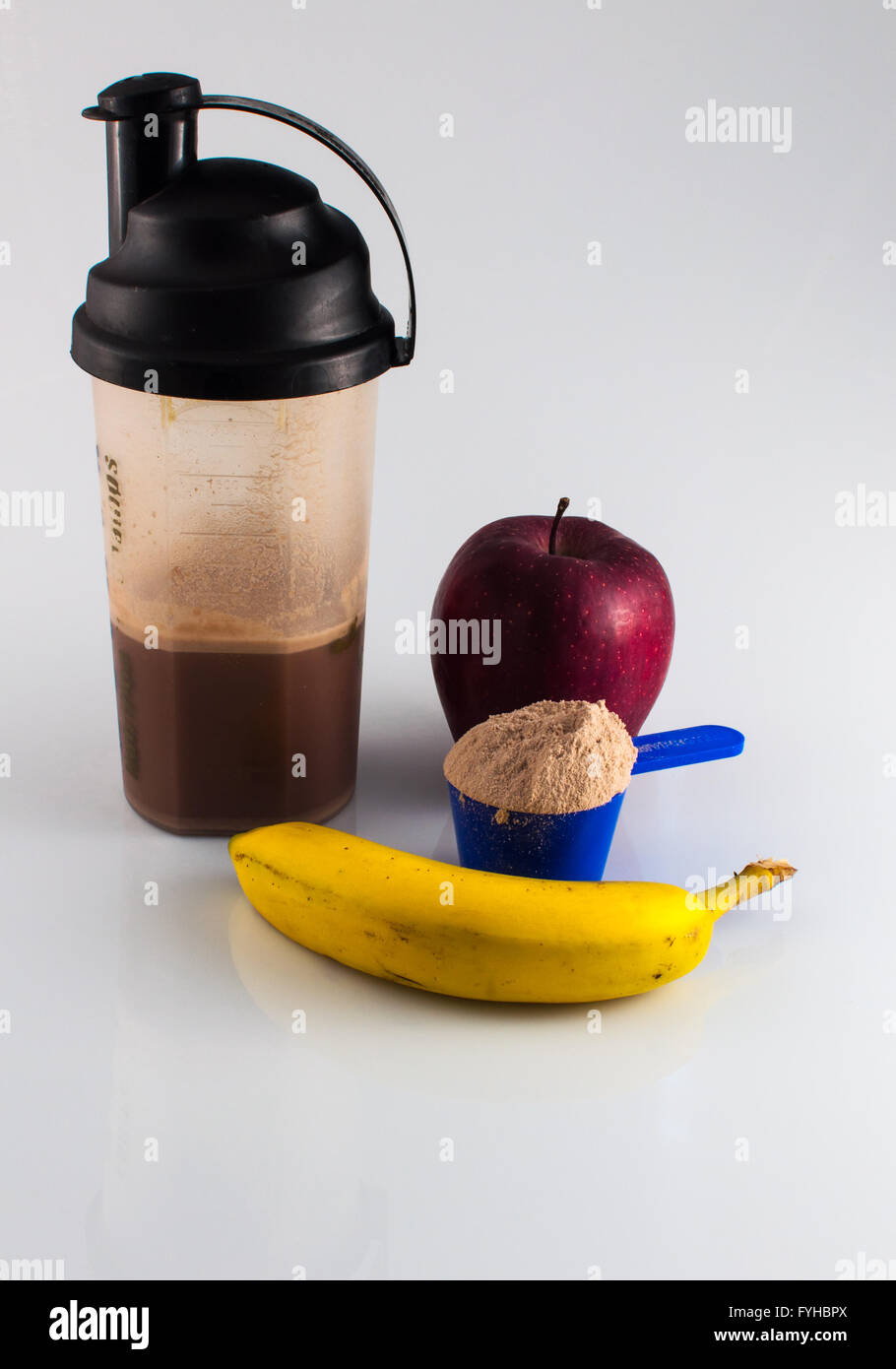 post workout meal with whey protein, shaker, banana and apple Stock