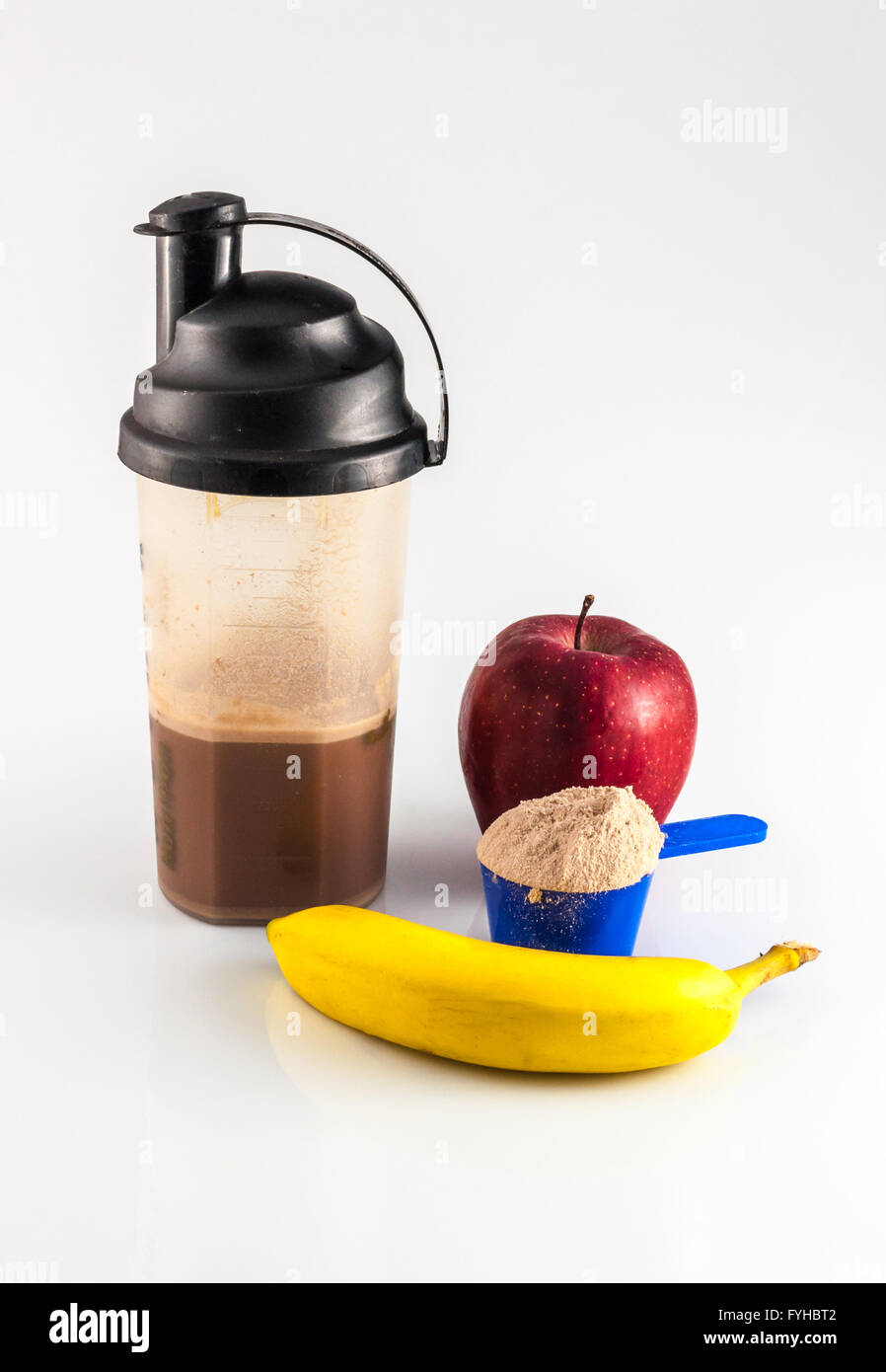 post workout meal with whey protein, shaker, banana and apple Stock