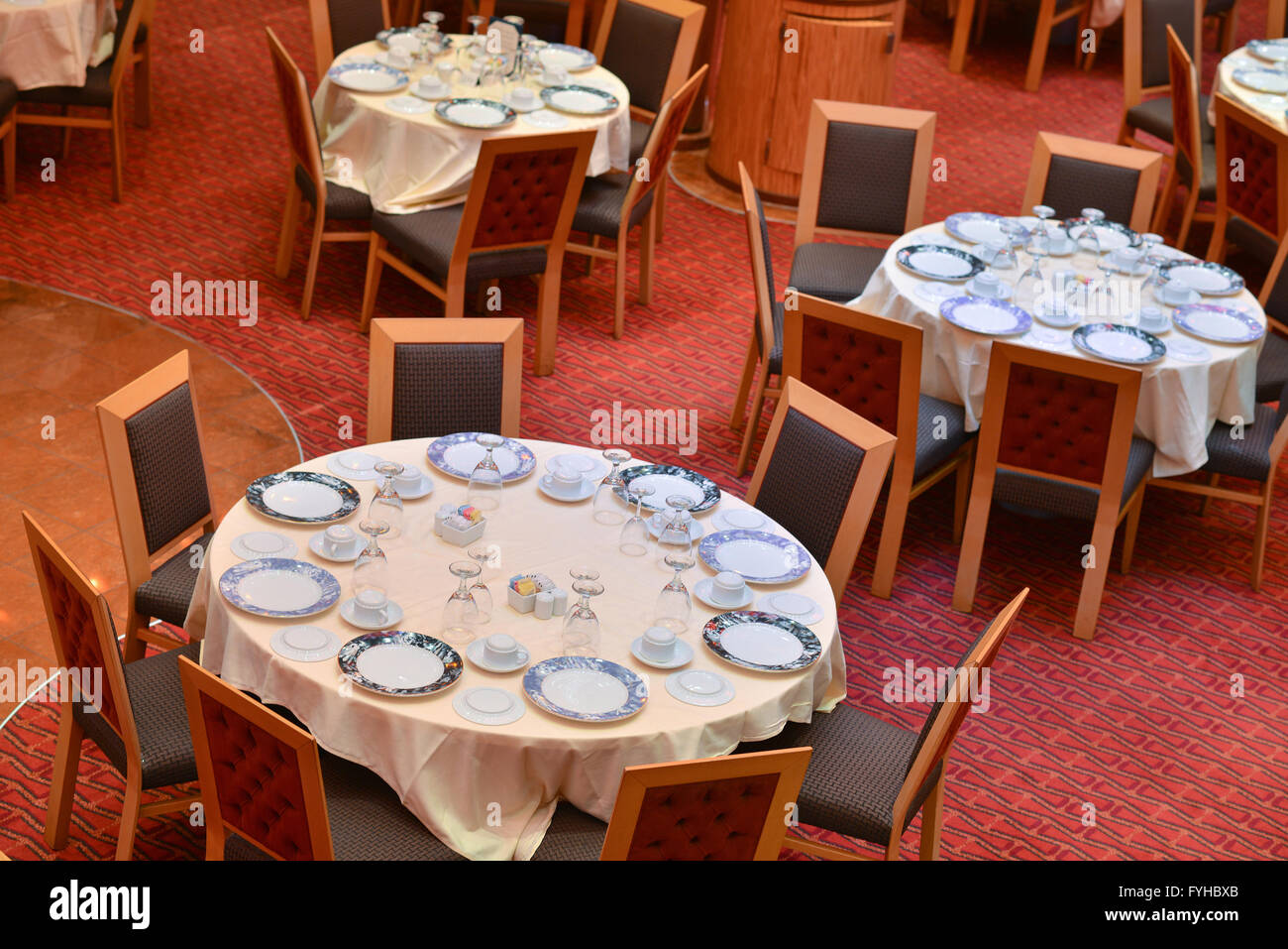 Few tables in dining room on a cruise ship Stock Photo
