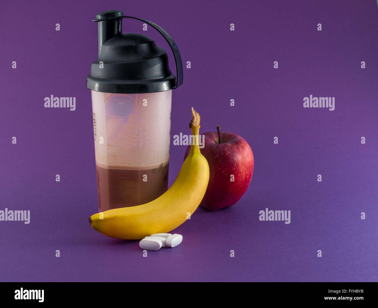 post workout meal with whey protein, shaker, banana and apple Stock