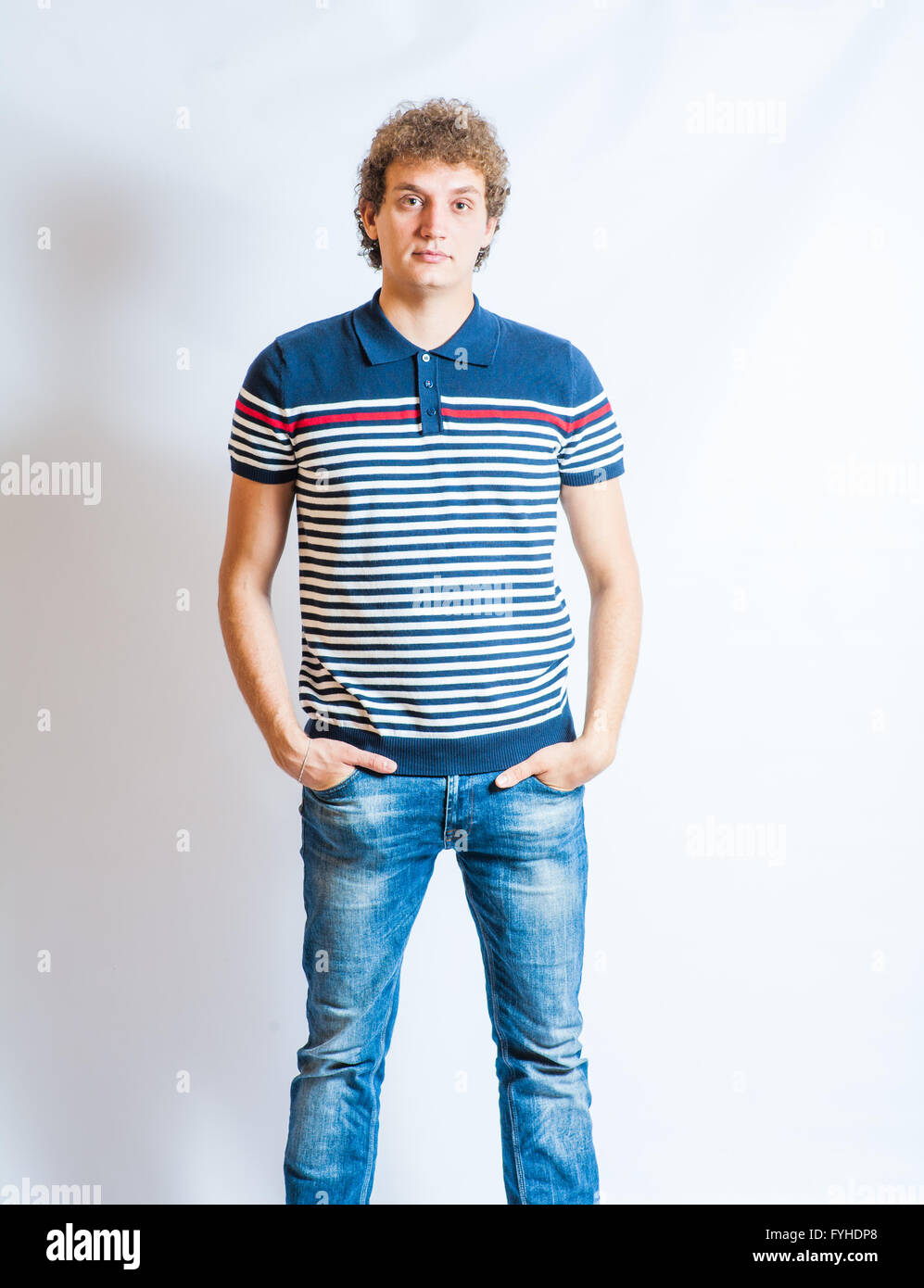 Young blonde adult caucasian man in casual clothes on a gray background. Not Isolated Stock Photo