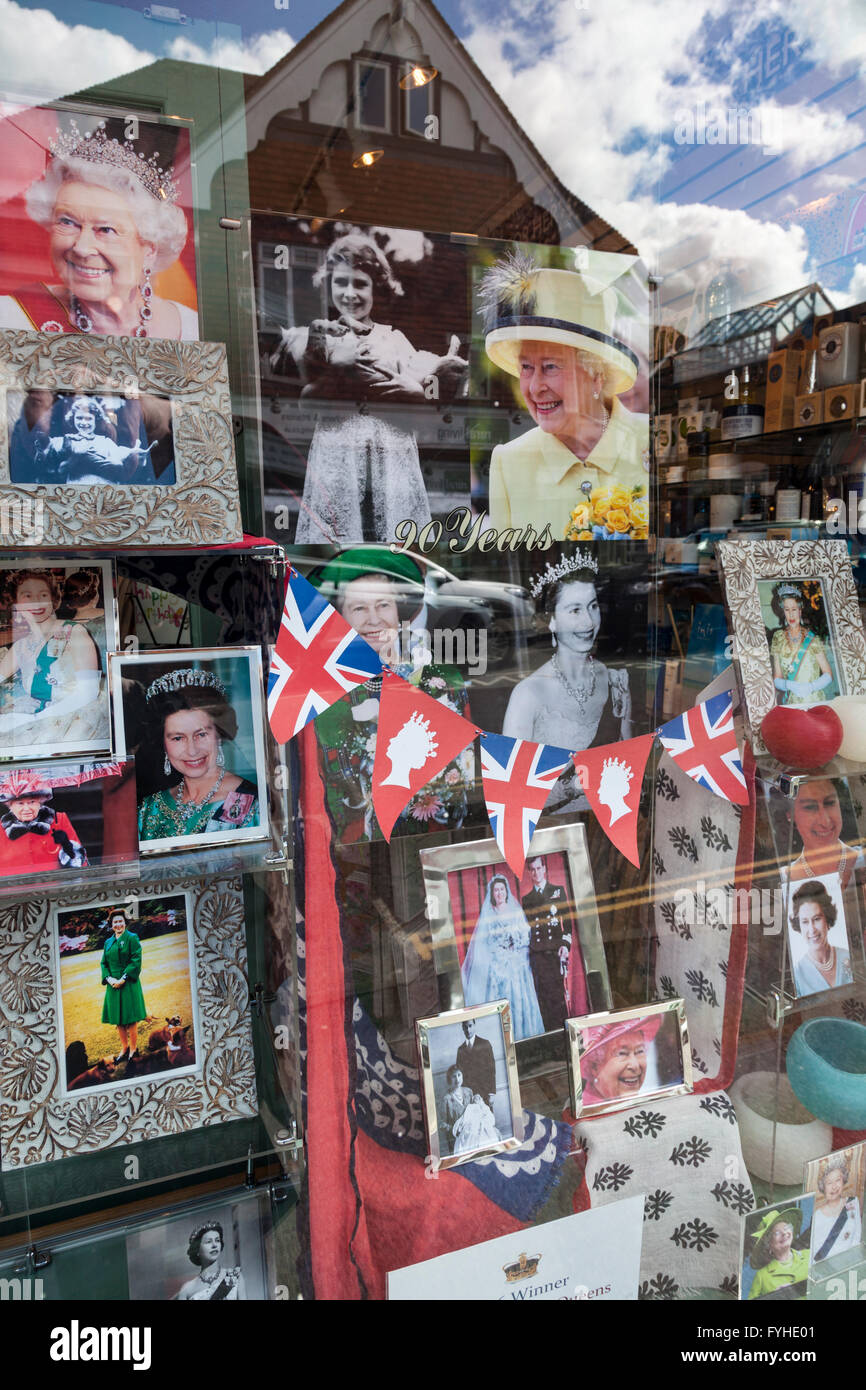 Collection of photographs of the Queen and Royal Family decorate a shop window in honour of the Queen's 90th birthday. Stock Photo