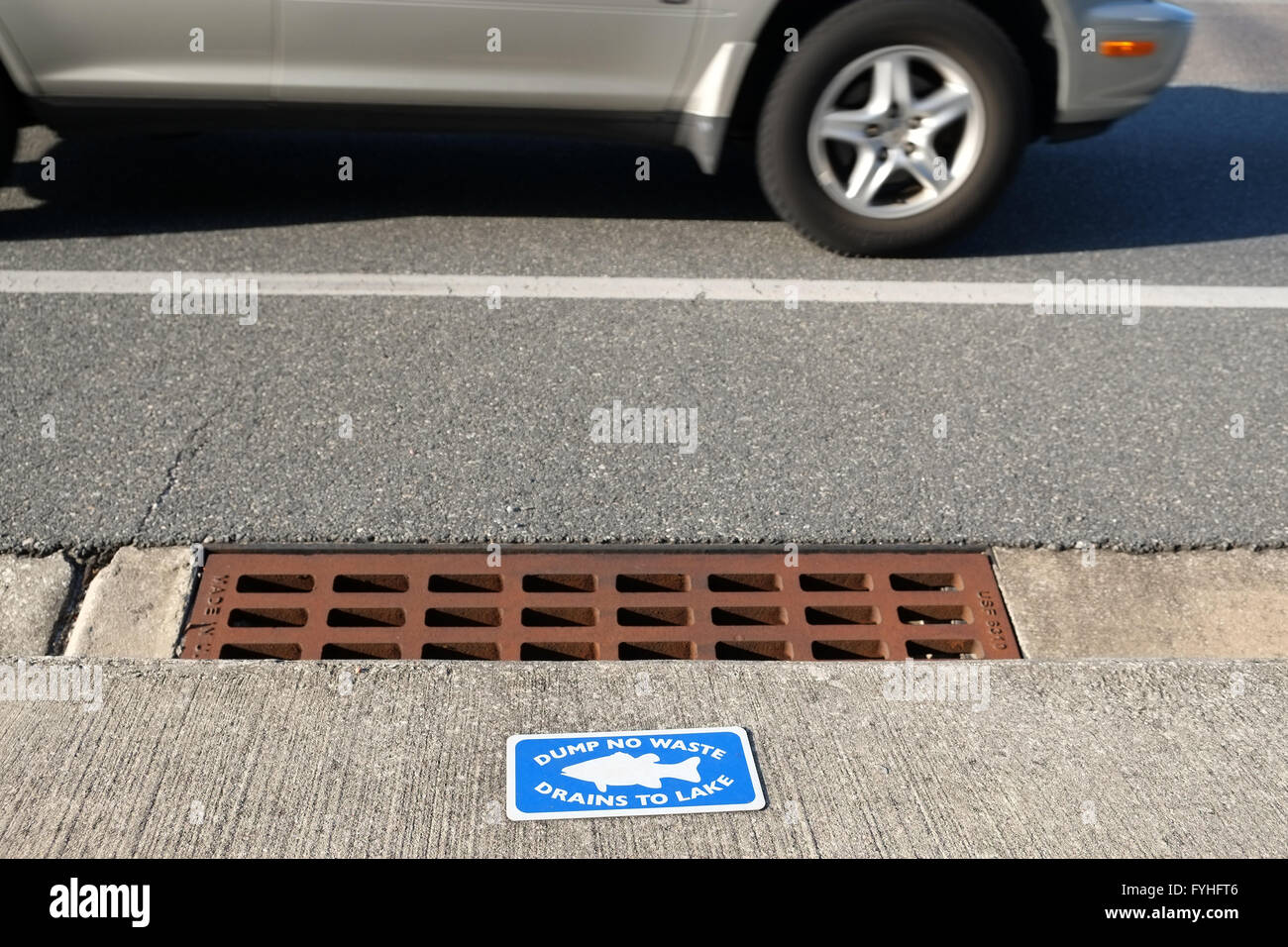 Dump no waste drains into lake sing on a highway storm outlet. April 2016 Stock Photo