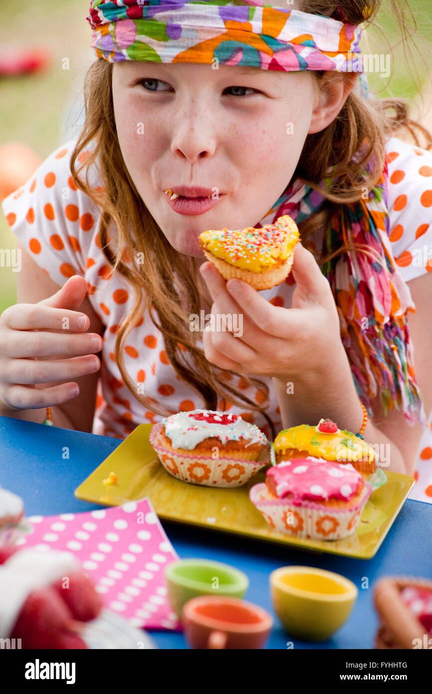 Happy eating cupcake girl Stock Photo Alamy