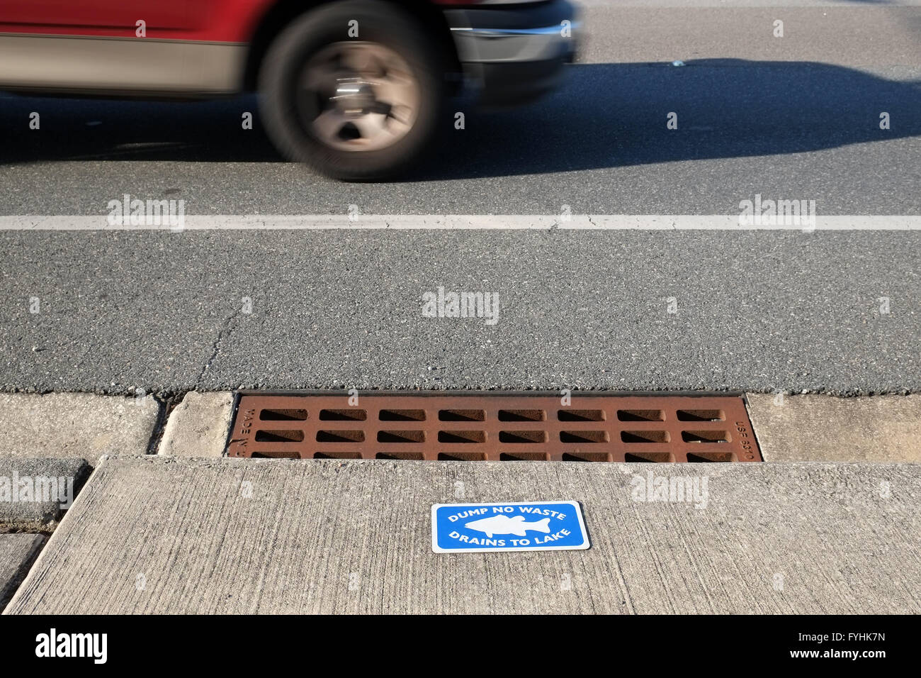 Dump no waste drains into lake sing on a highway storm outlet. April 2016 Stock Photo