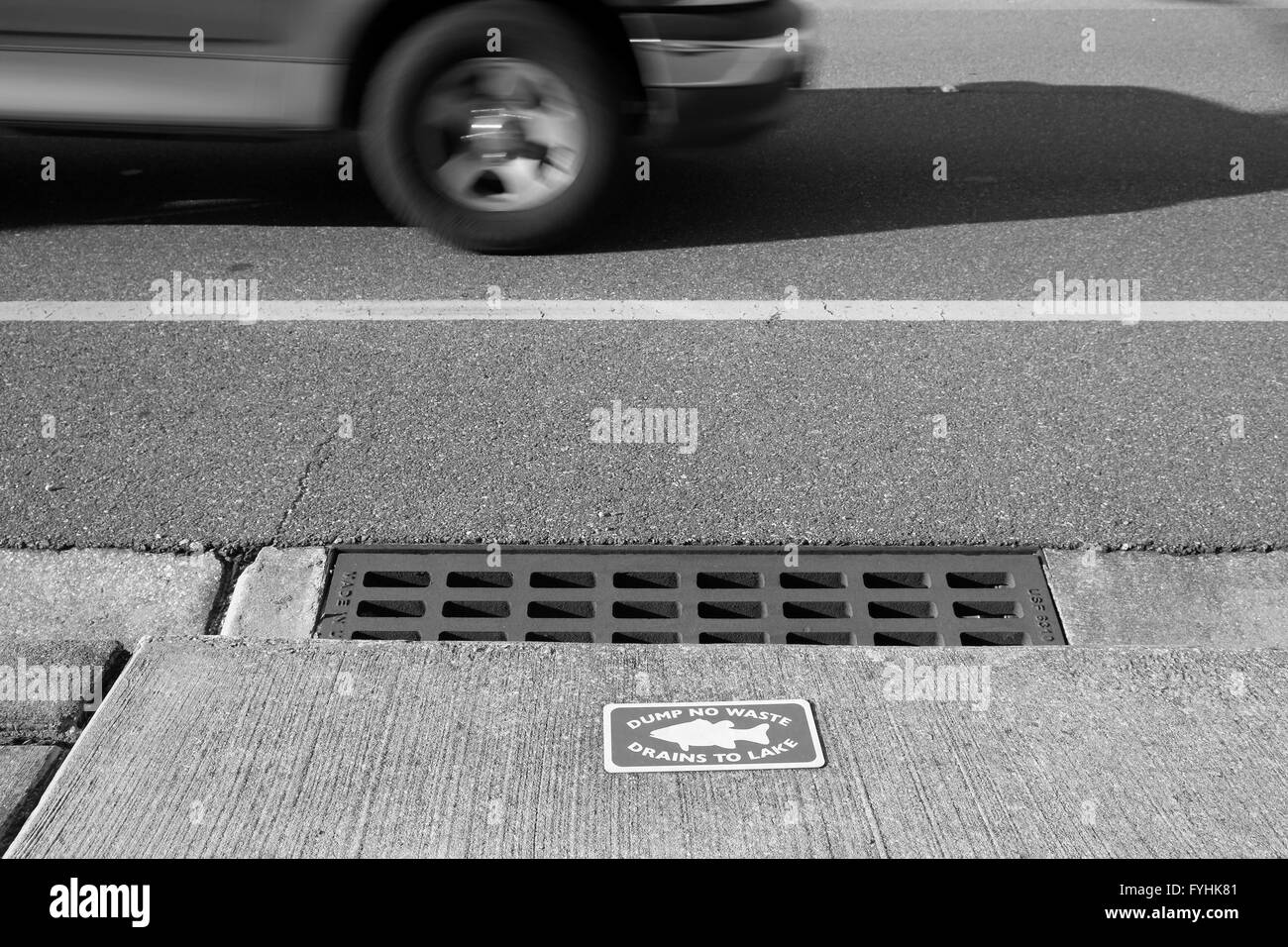 Dump no waste drains into lake sing on a highway storm outlet. April 2016 Stock Photo