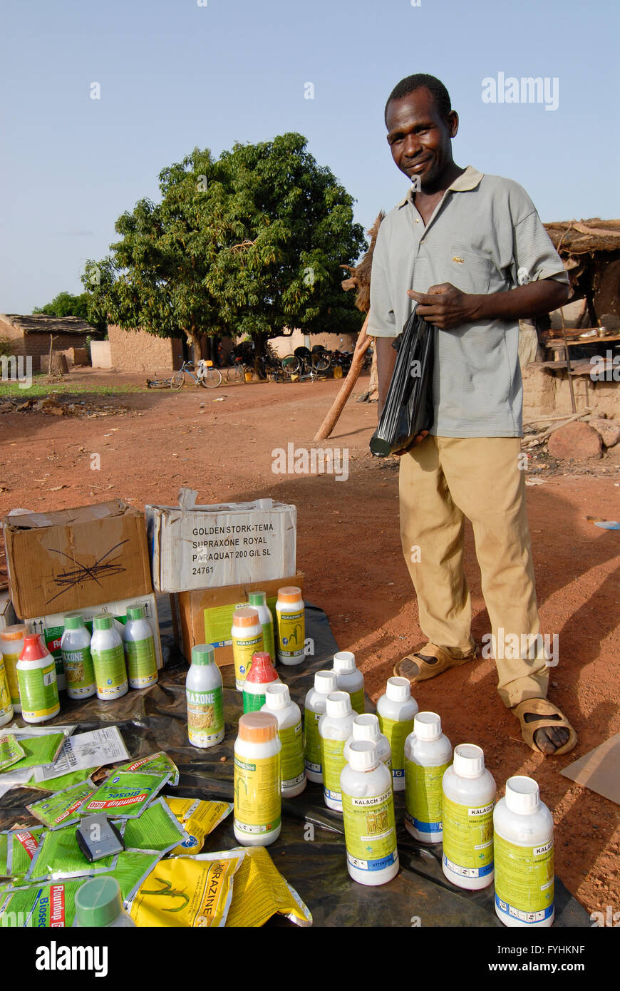 Burkina Faso, street vendor sell chemical pesticides for cotton and other crop to farmer at village market , farmer often can not read the instruction and danger their health and the environment with wrong usage   -  agriculture pest control pesticide  | [ copyright (c) Joe Stock Photo