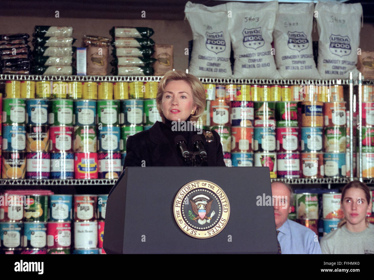 U.S. First Lady Hillary Rodham Clinton speaks to the media before joining in to help prepare lasagna at the DC Central Kitchen to provide a Christmas meal for the homeless December 21, 1998 in Washington, DC. The First Lady joined President Bill Clinton during the annual volunteering at the shelter. Stock Photo