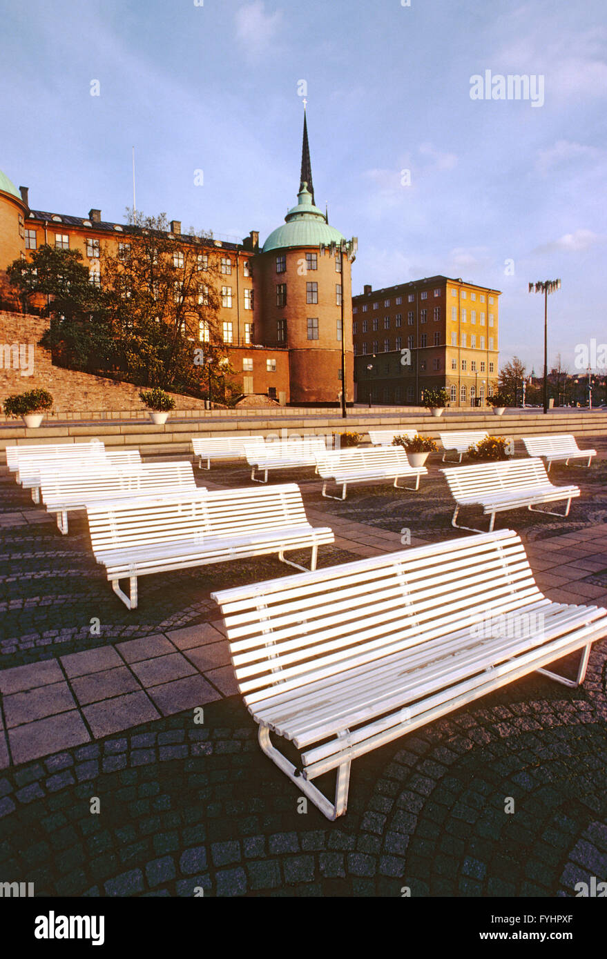 Empty park benches along harbor; Stockholm; Sweden Stock Photo