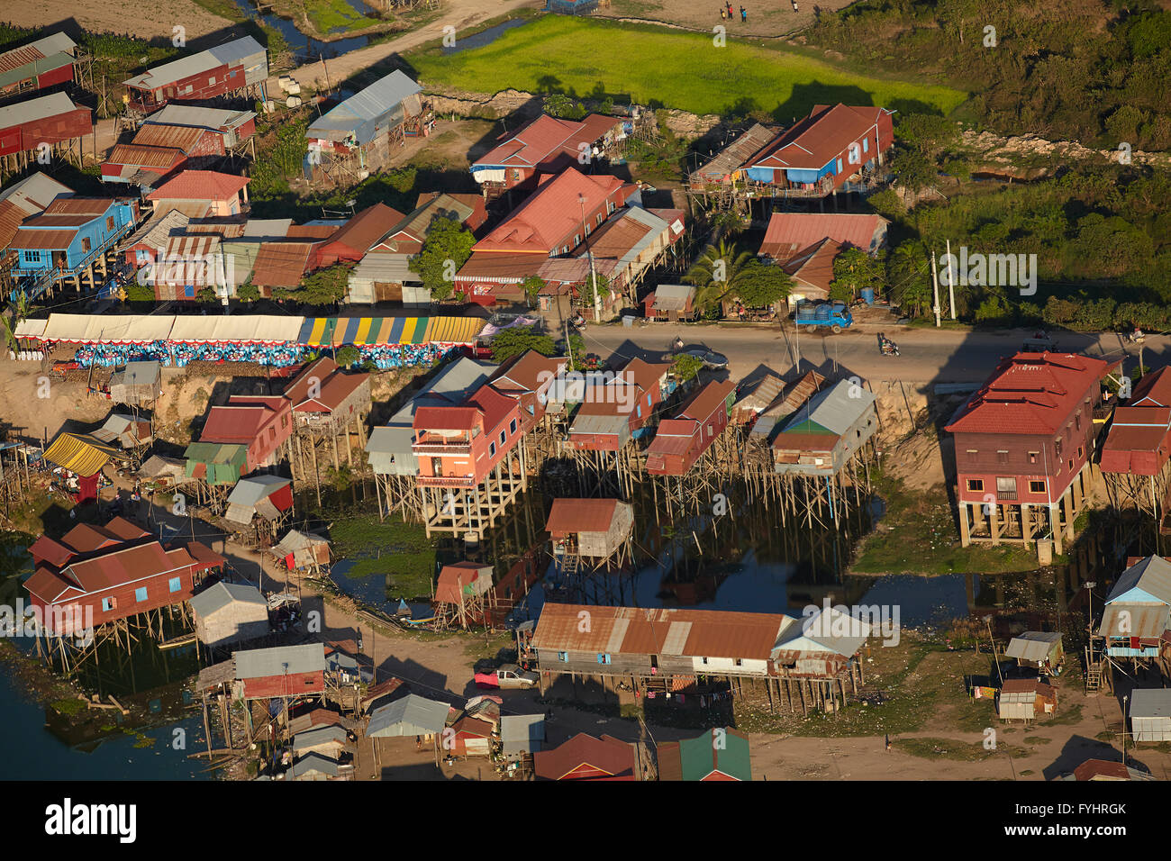 Village of stilt houses that are seasonally flooded, Phnom Krom, near Siem Reap, Cambodia - aerial Stock Photo
