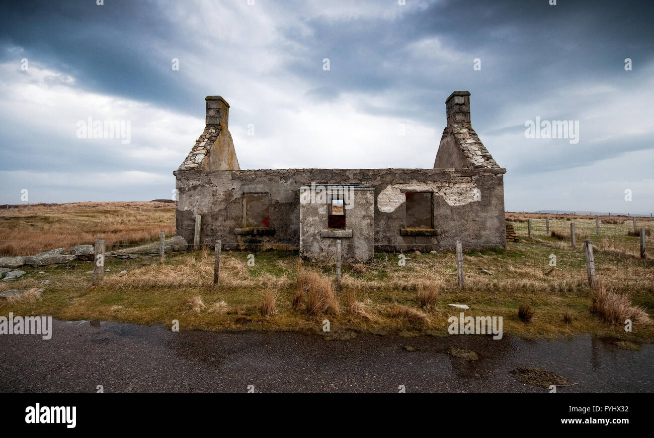 The Moine House, the ruin of a traditional stone cottage on bleak and remote moorland in Sutherland in the Scottish Highlands. Stock Photo