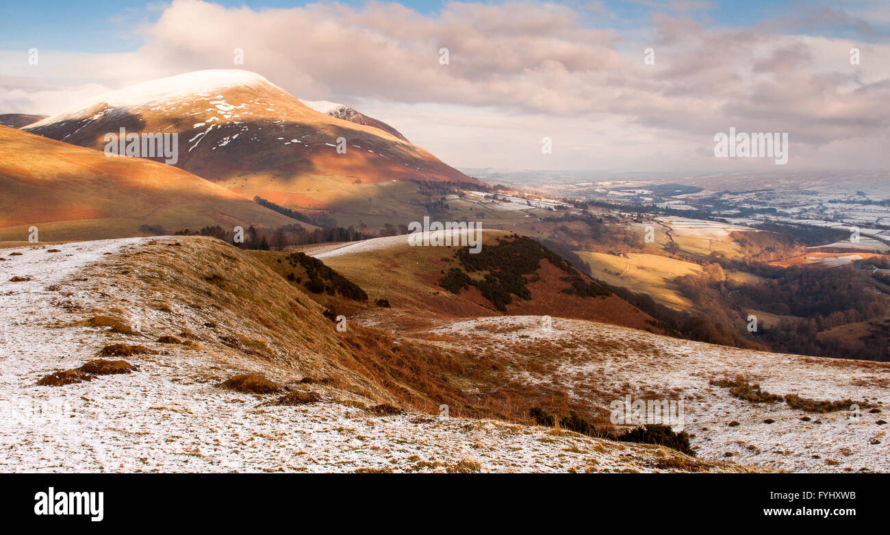 Snow covers the rolling hills of Latrigg and Blencathra mountain in the English Lake District. Stock Photo