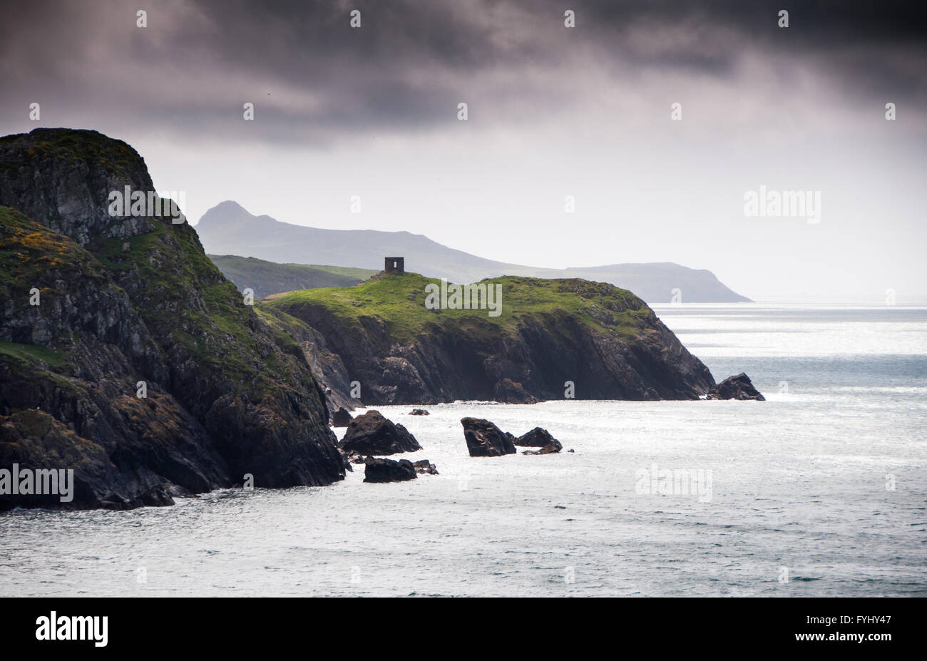Old quarry buildings top the cliffs at Abereiddy in the Pembrokeshire Coast National Park, Wales. Stock Photo