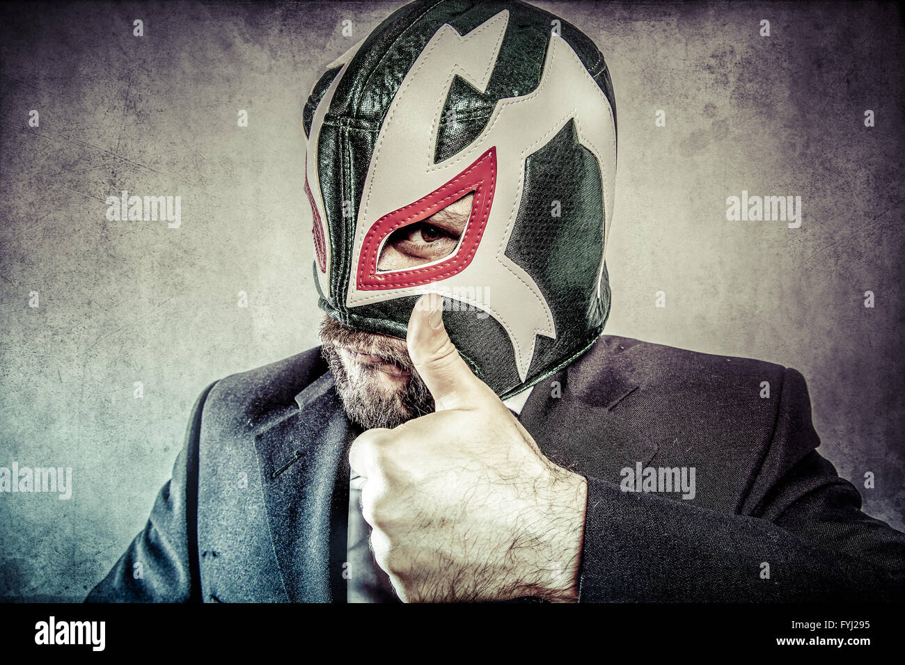 all it is ok, aggressive executive suit and tie, Mexican wrestler mask Stock Photo