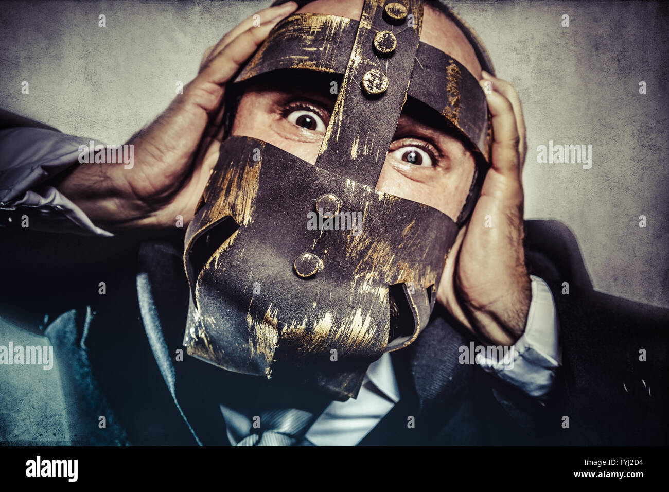 pulling, dangerous business man with iron mask and expressions Stock Photo