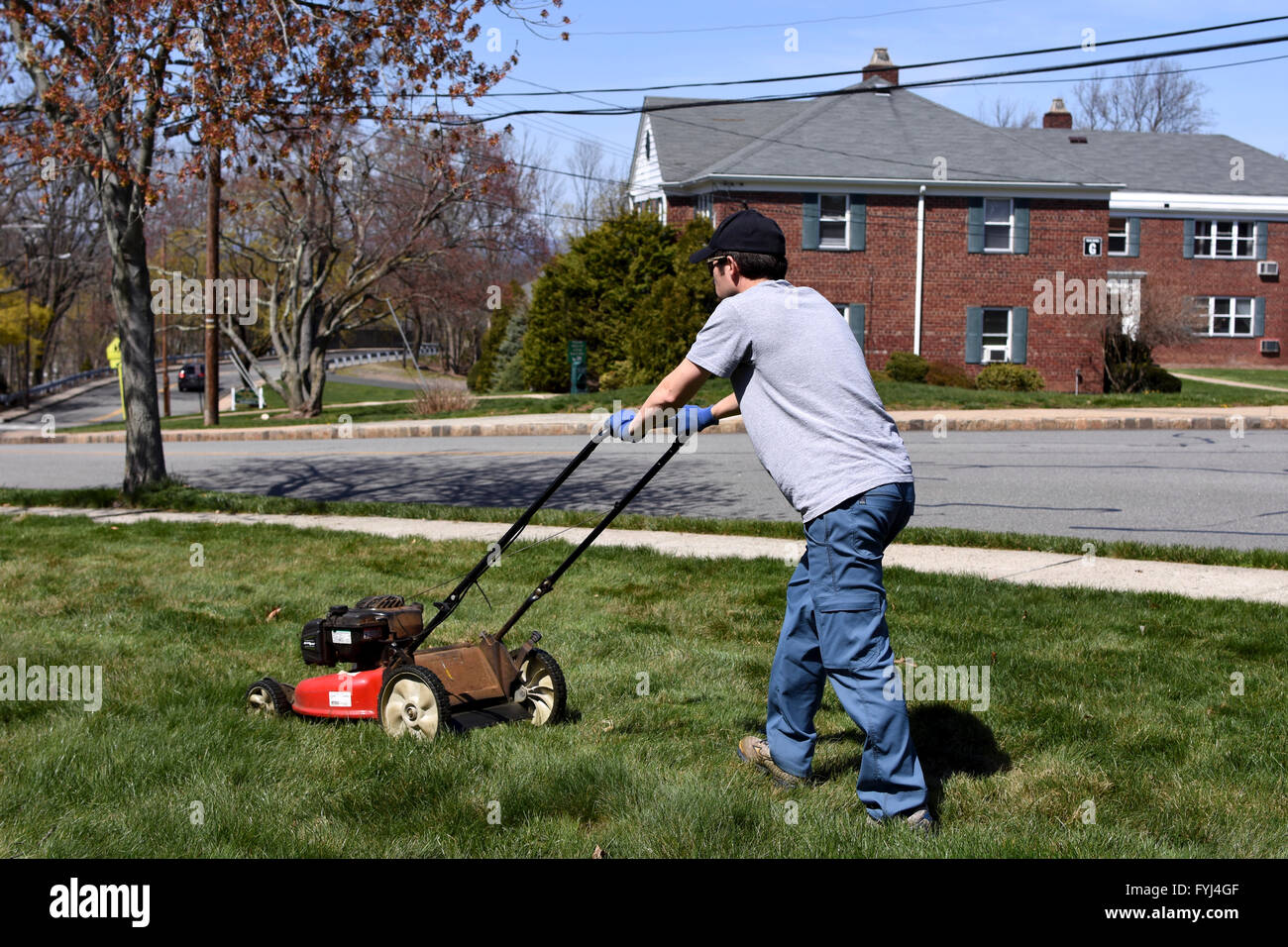 man mowing lawn grass Stock Photo