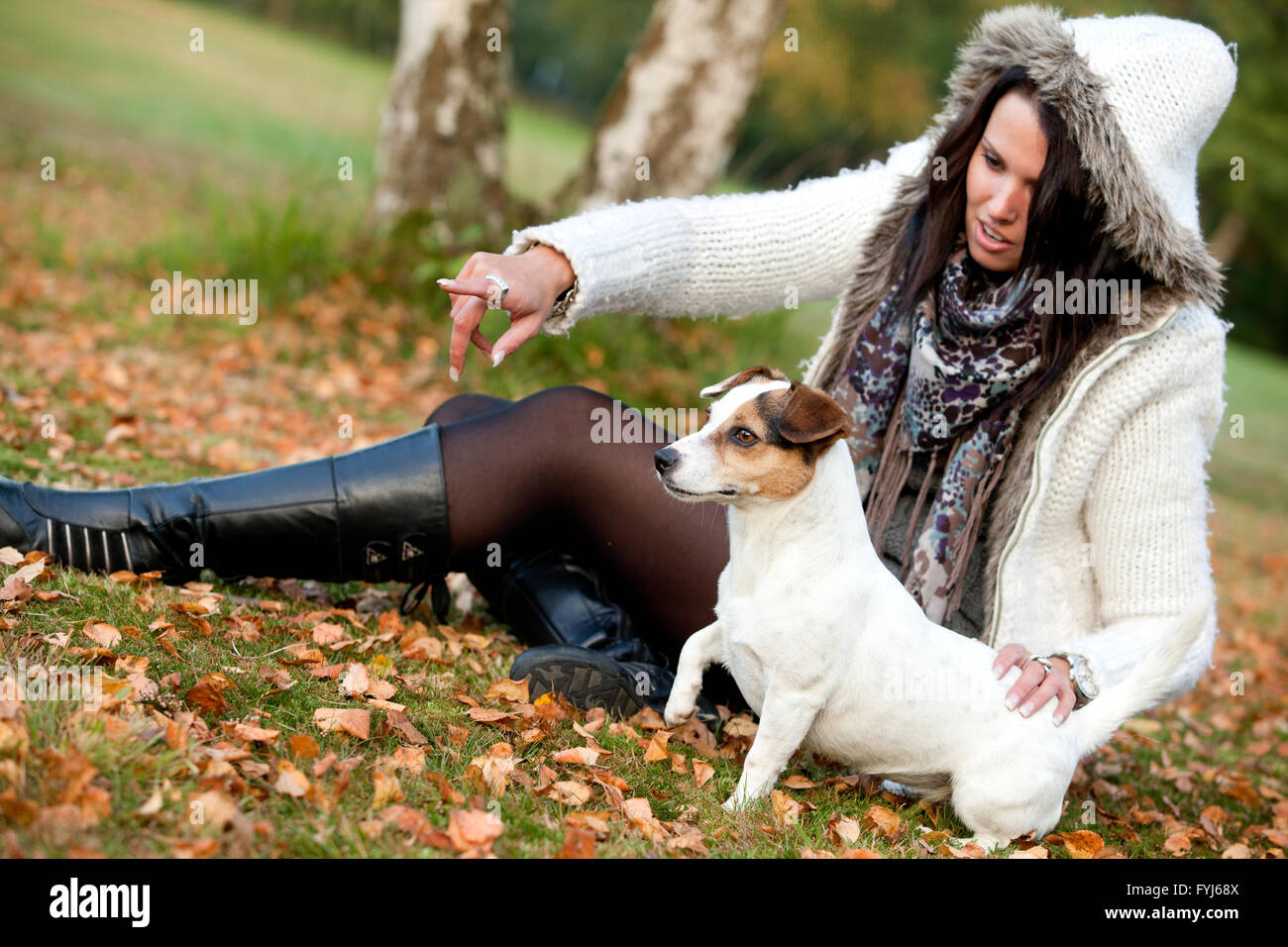 Woman with her dog is pointing Stock Photo