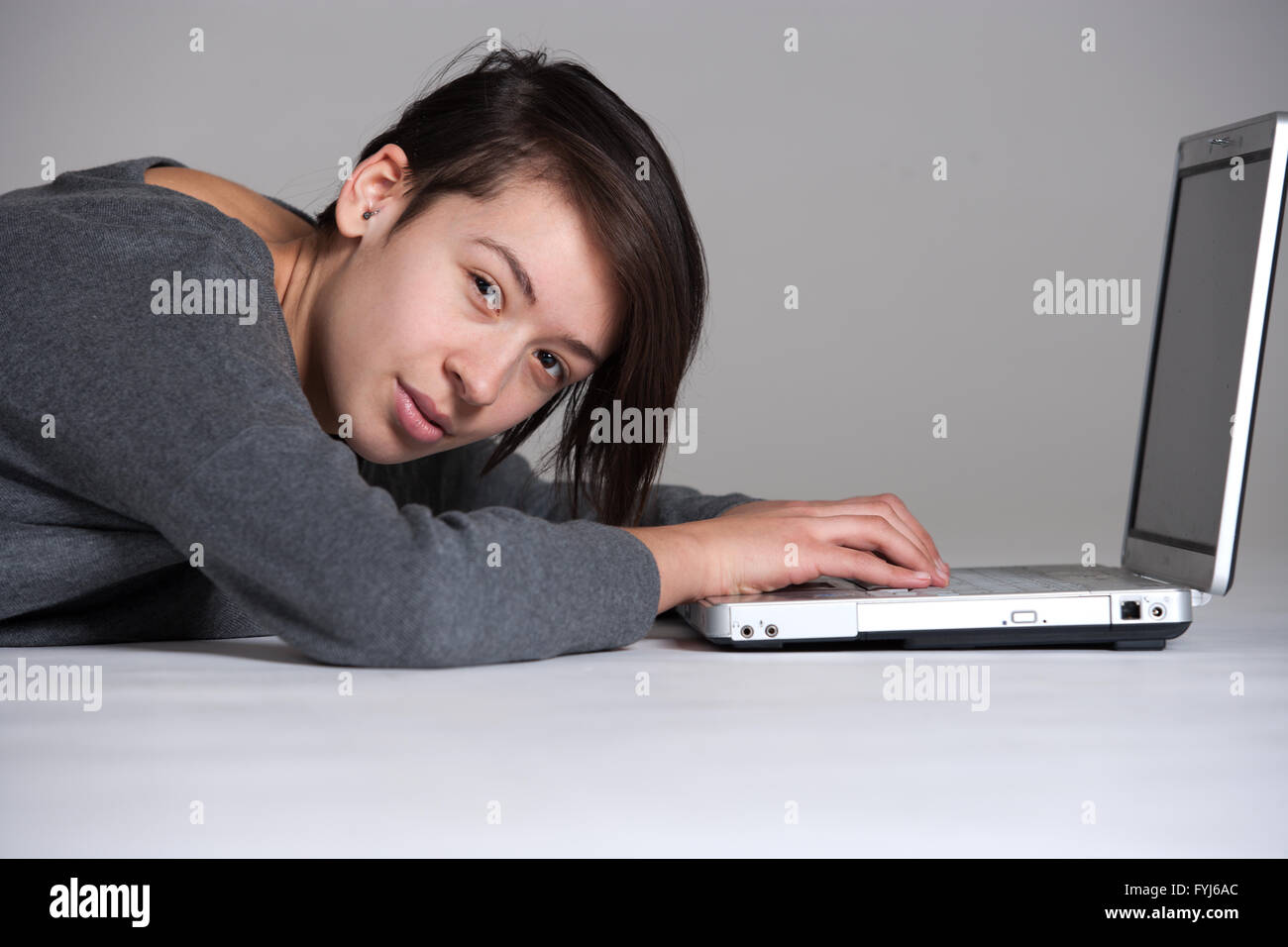 Young woman on floor with notebook Stock Photo