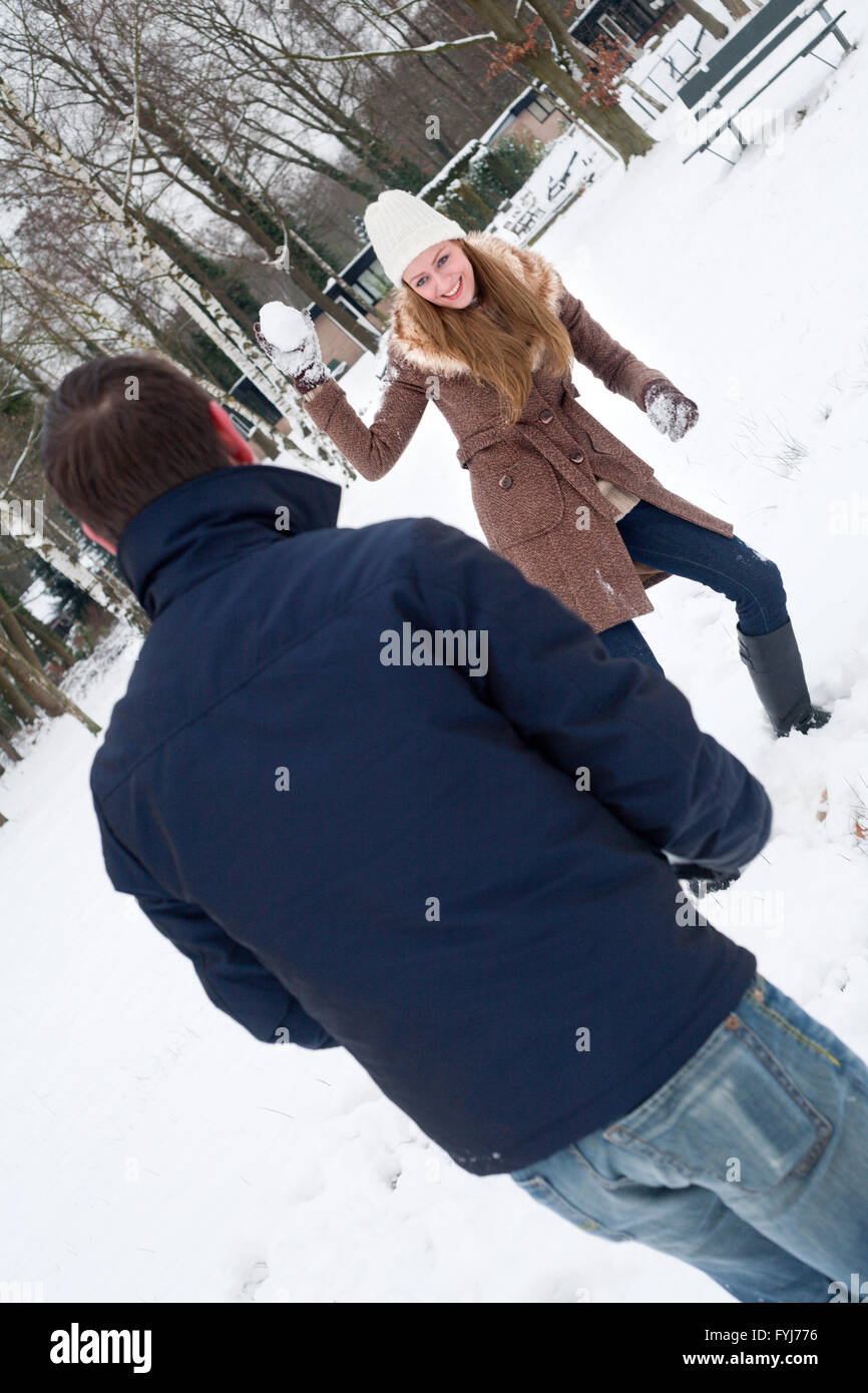 Young couple having snowball fight hi-res stock photography and images -  Alamy