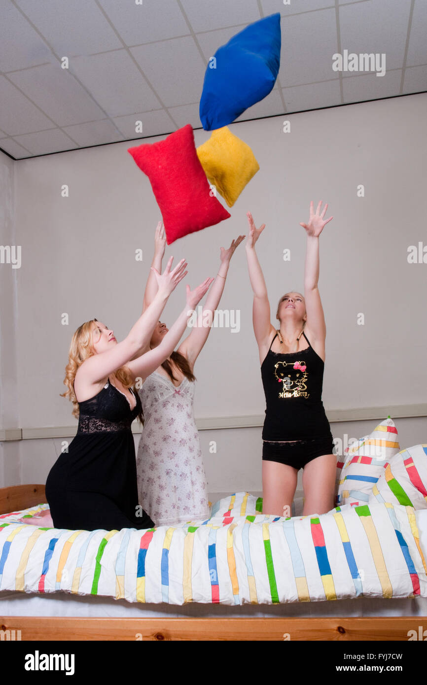 throwing with pillows at a pyjama party Stock Photo