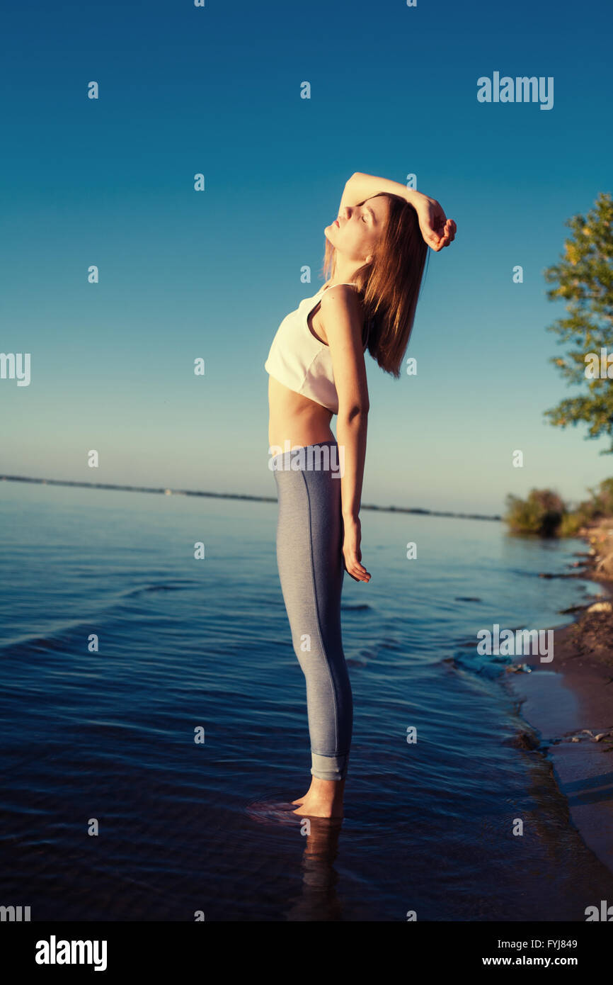 beautiful young girl in the morning in the water Stock Photo - Alamy