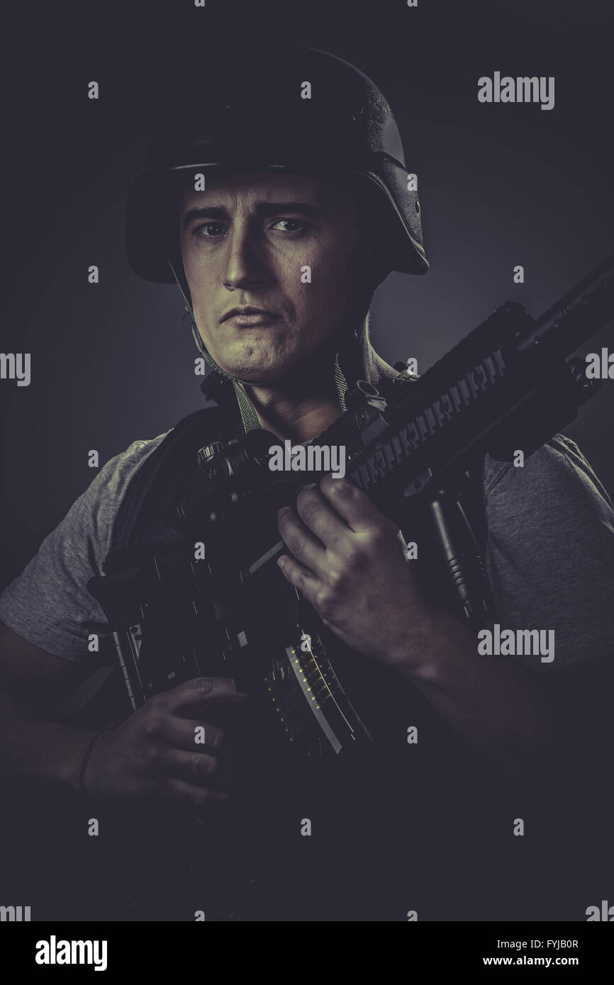 Fight, paintball sport player wearing protective helmet aiming pistol