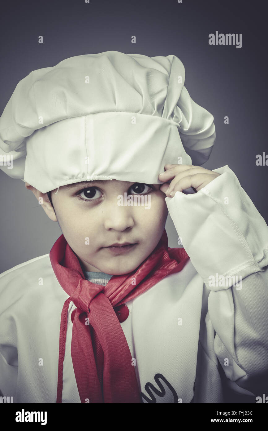small child dress funny chef, cooking utensils Stock Photo Alamy