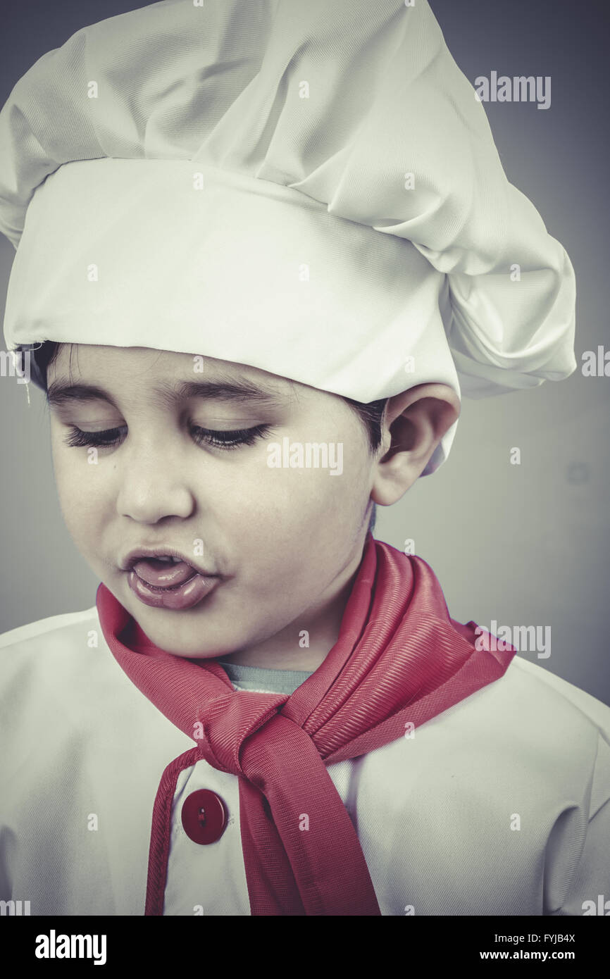 cheerful child dress funny chef, cooking utensils Stock Photo Alamy