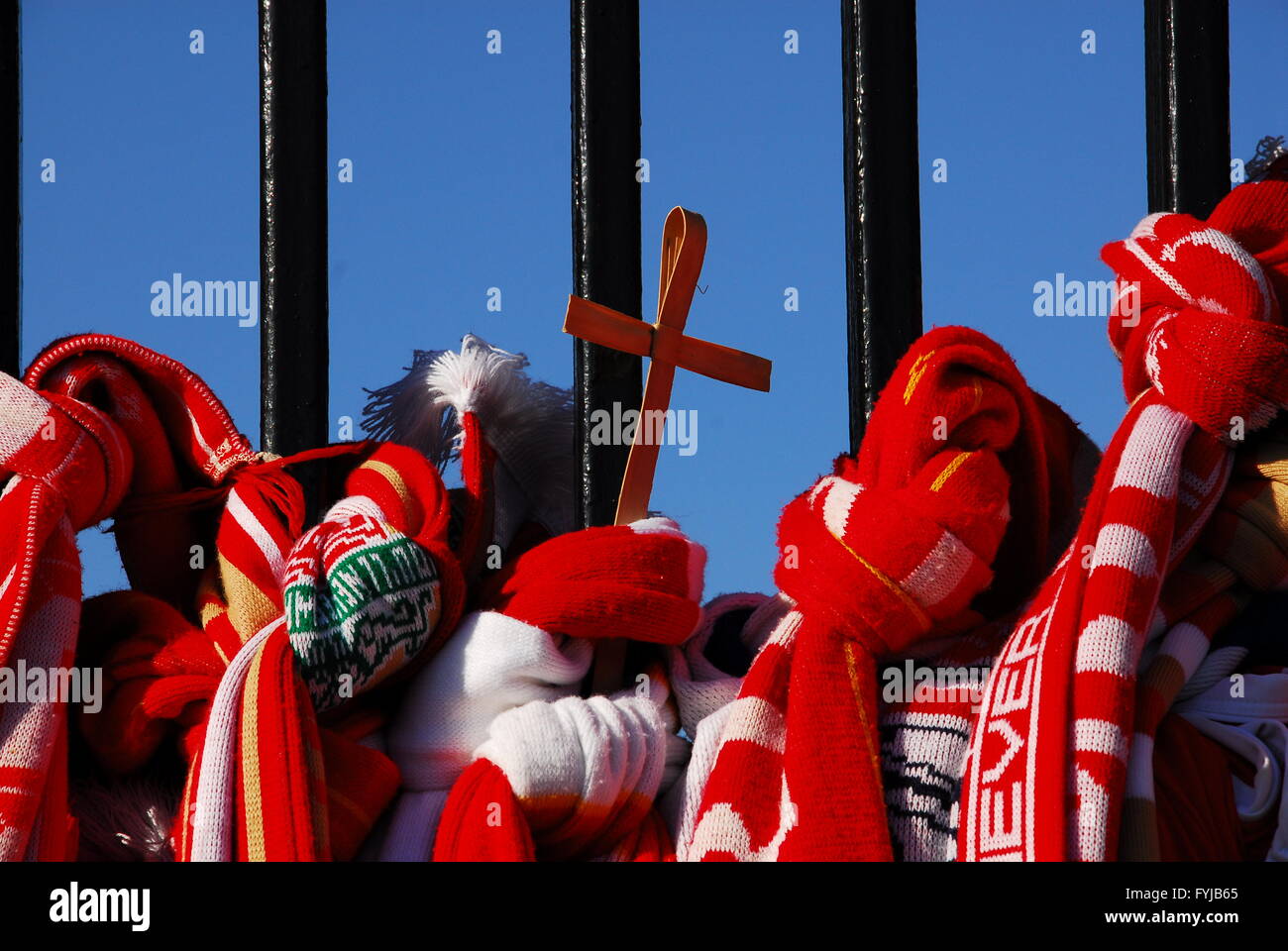 Liverpool football scarves and cross tied to the Shankly gates at Liverpool Football Club. Stock Photo