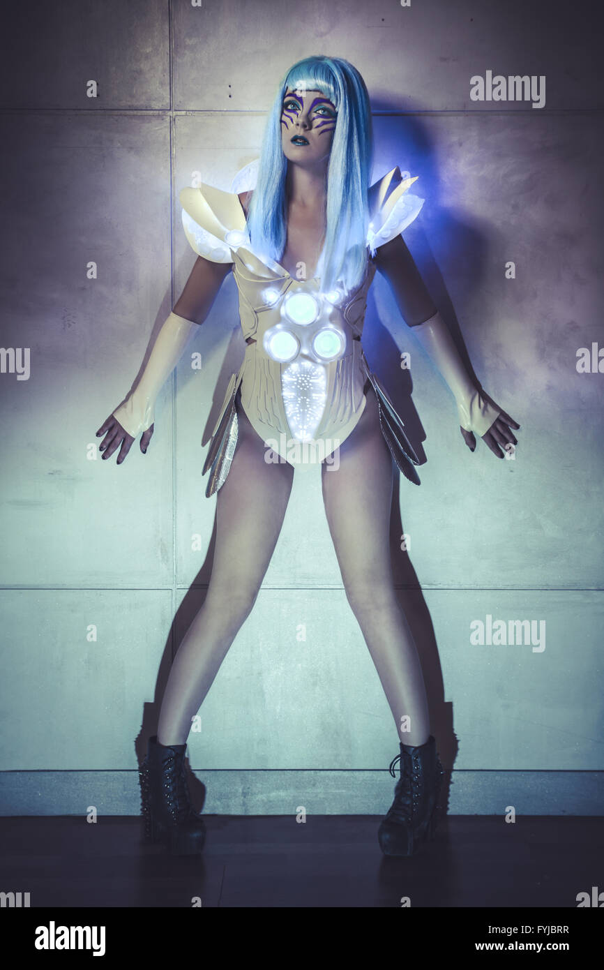 robot woman on wall with blue lights, light suit with neon and LED colors Stock Photo
