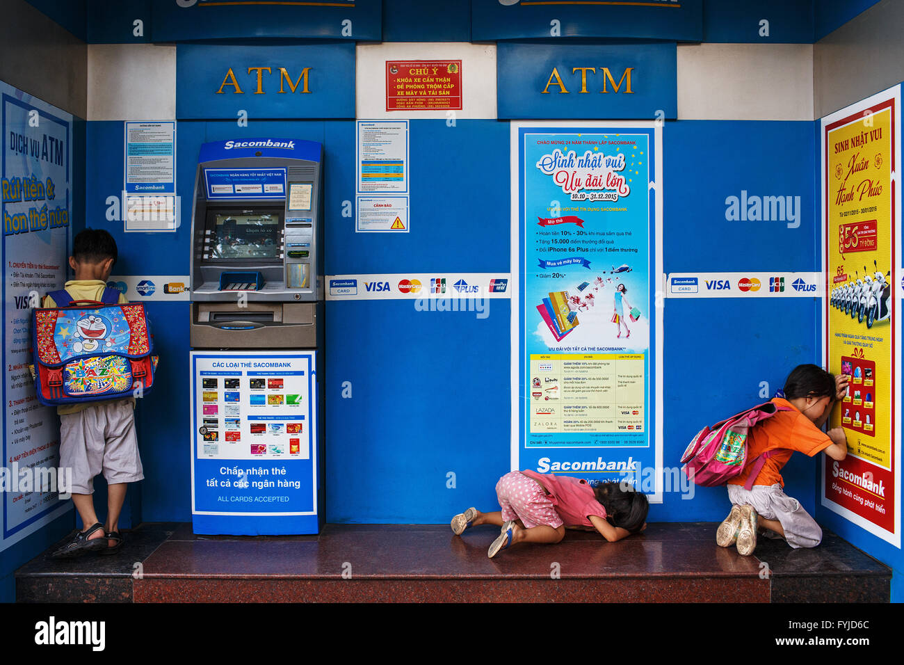 Children and ATM machines in Ho Chi Minh City, Vietnam Stock Photo