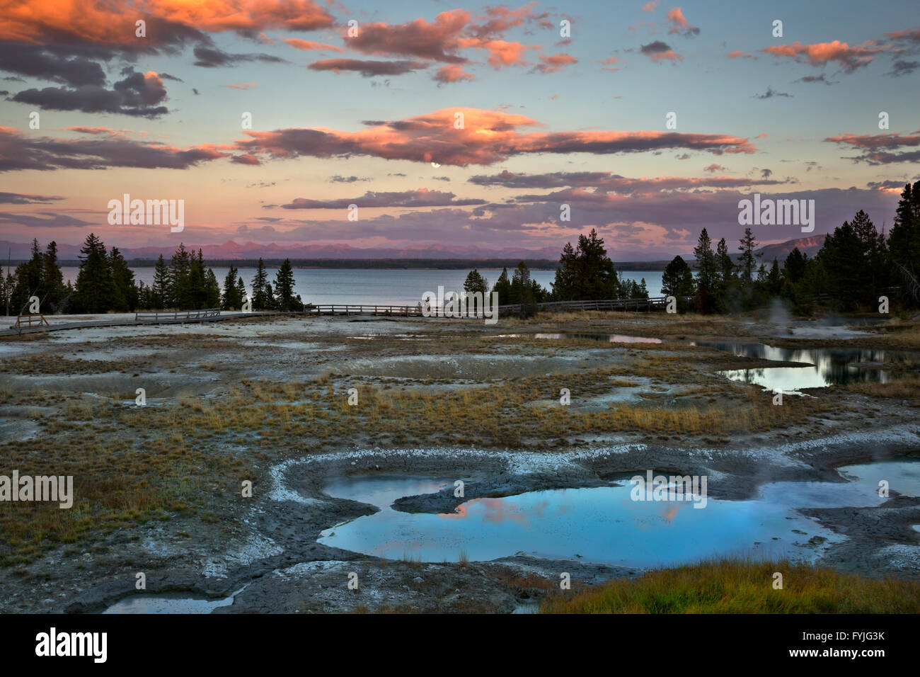WYOMING - Clouds reflecting in hot spring pools at sunset in the West Thumb Geyser Basin of Yellowstone National Park. Stock Photo