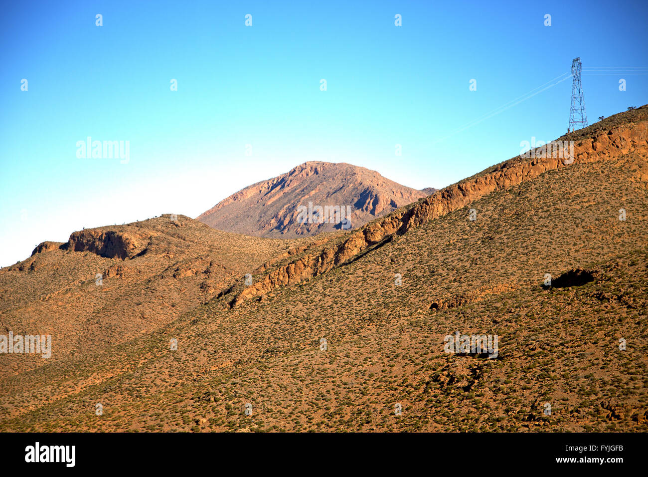 valley in africa morocco electrical line high voltage power Stock Photo