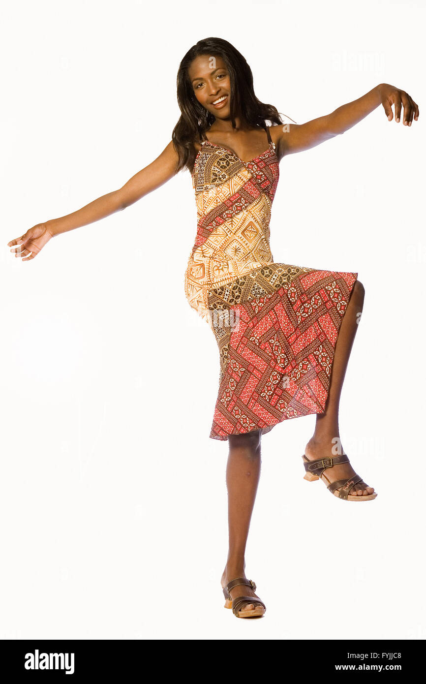 Dark female model dancing in her new dress Stock Photo