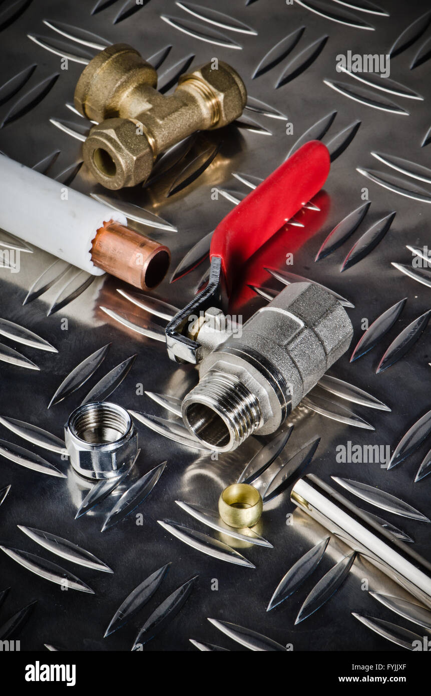 Plumbing inlet pipe valve on a metal surface Stock Photo - Alamy