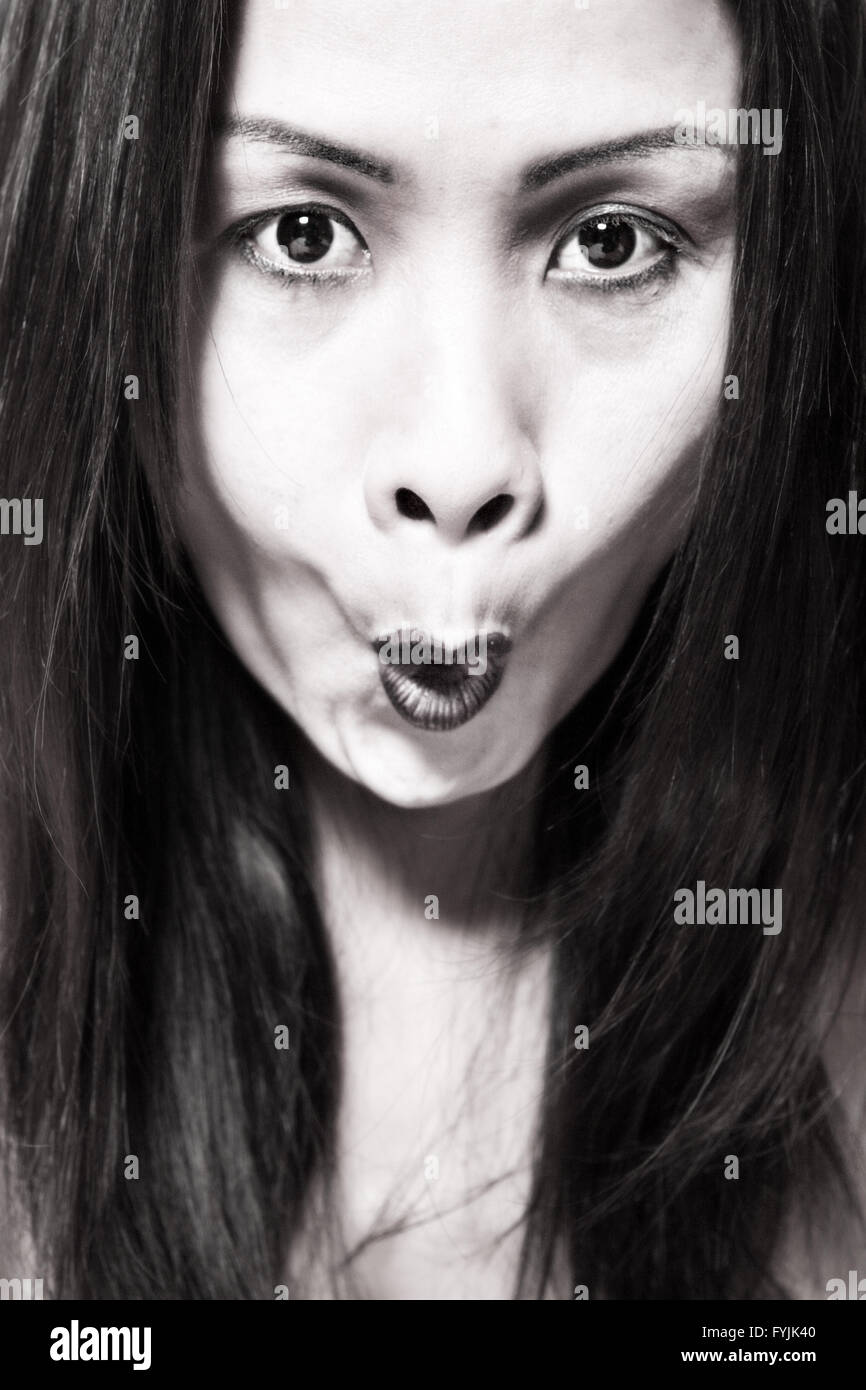 Asian woman making a scary face Stock Photo