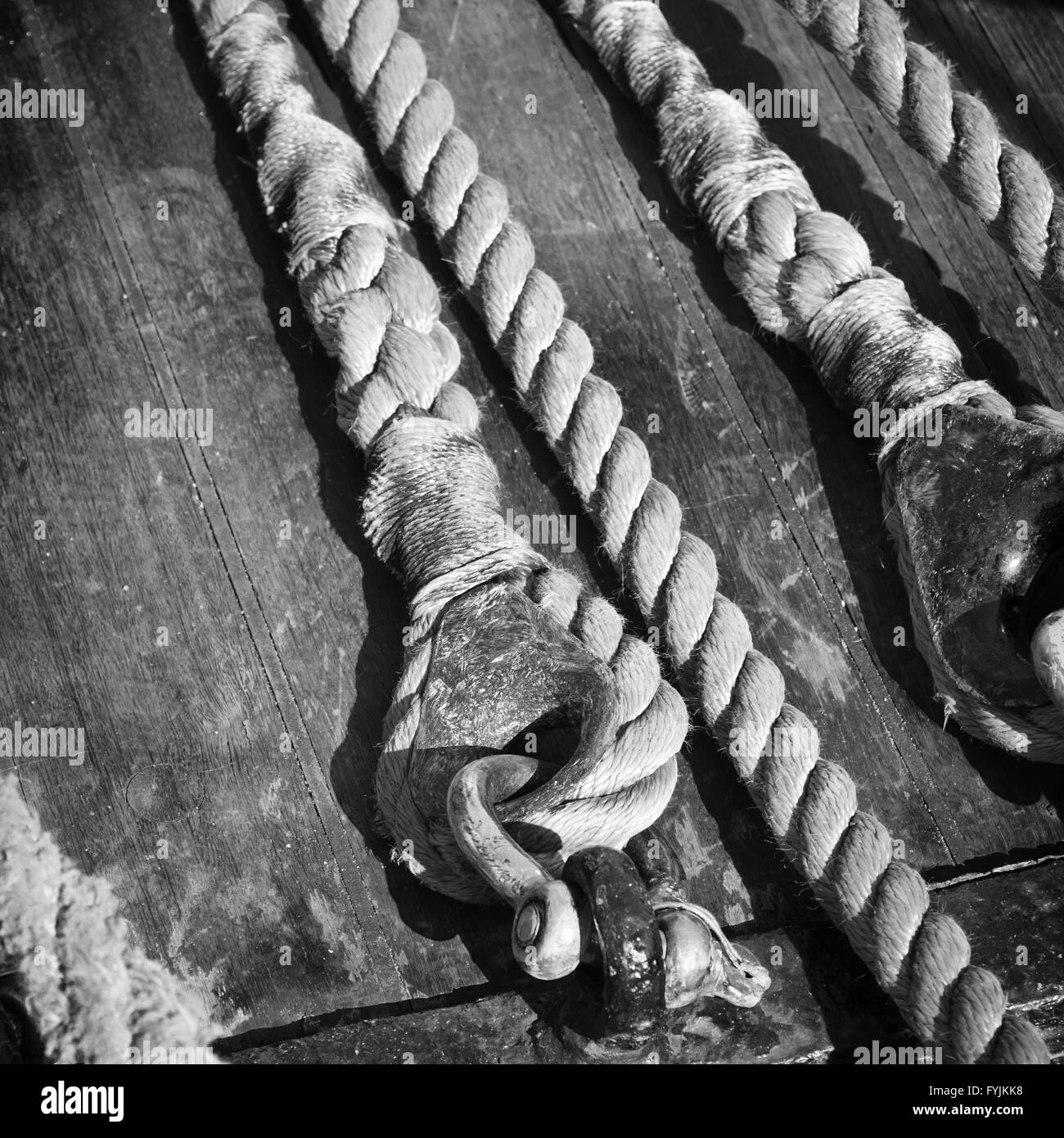 The ropes braided in bays on an ancient sailing vessel Stock Photo