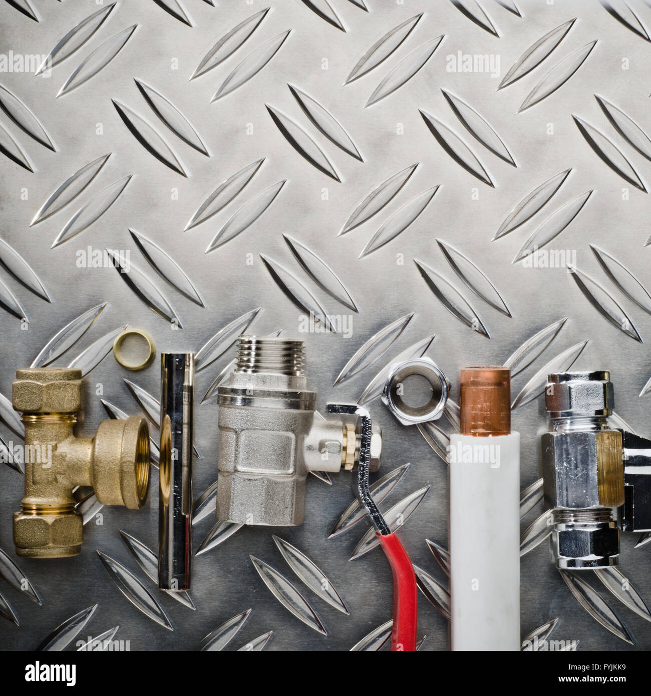 Plumbing inlet pipe valve on a metal surface Stock Photo