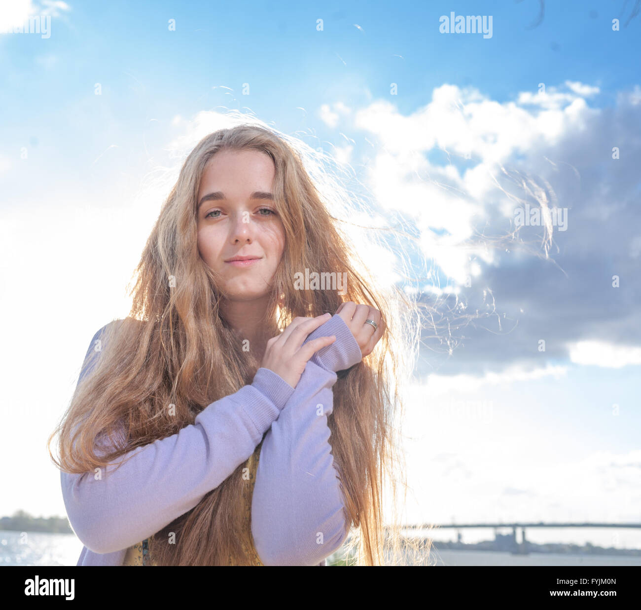 Portrait of happy woman smiling against clear sky Stock Photo - Alamy