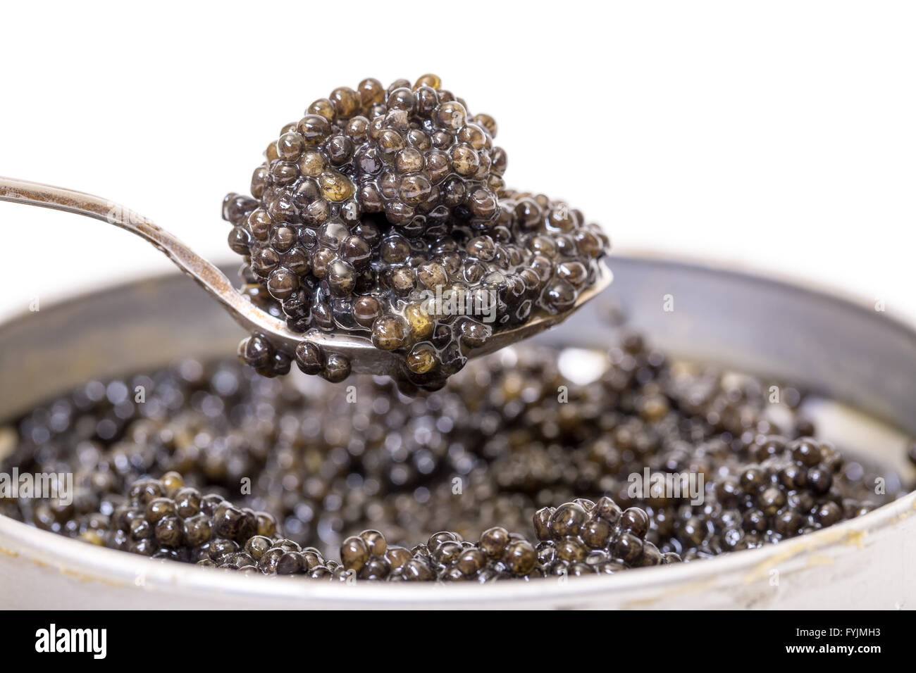 Black caviar in spoon from metal can, high angle Stock Photo Alamy