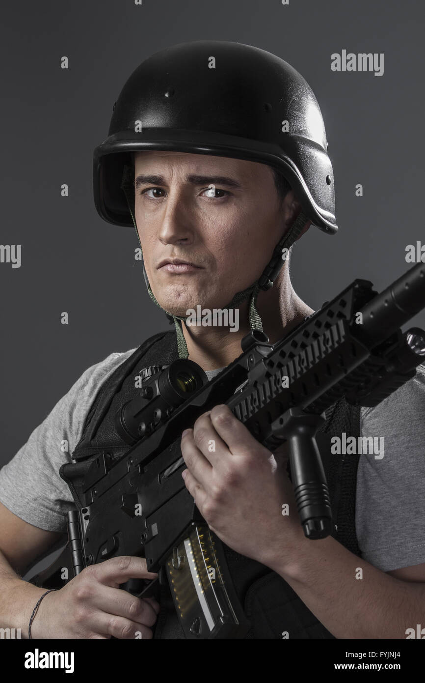 Gunfire, paintball sport player wearing protective helmet aiming pistol