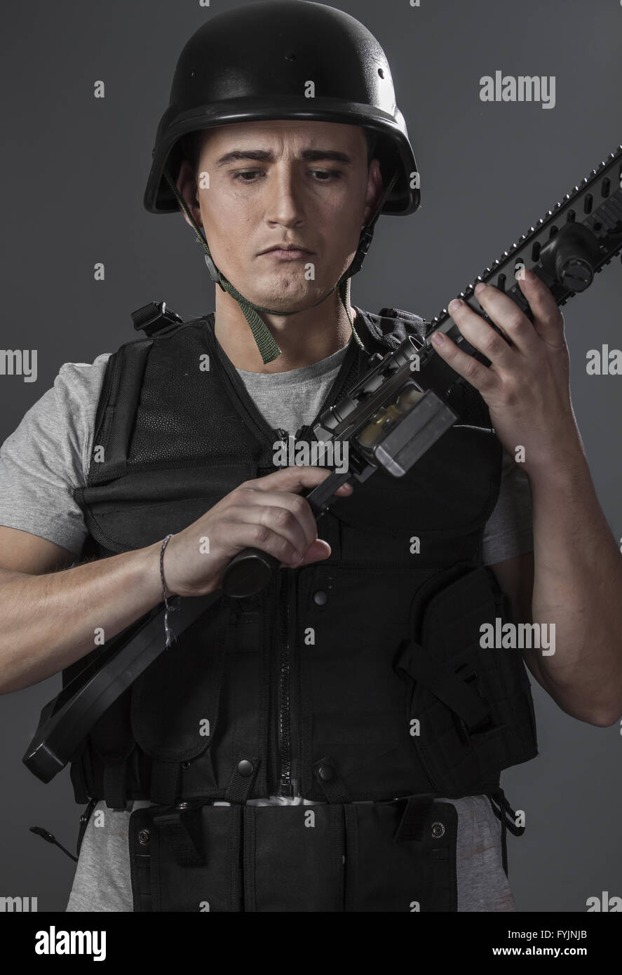 Fight, paintball sport player wearing protective helmet aiming pistol