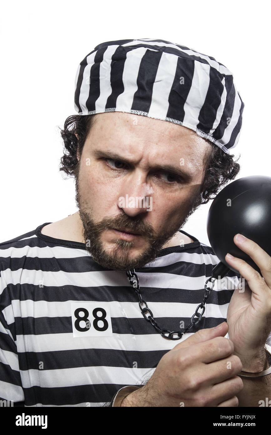 Fun, one caucasian man prisoner criminal with chain ball and handcuffs in studio isolated on white background Stock Photo